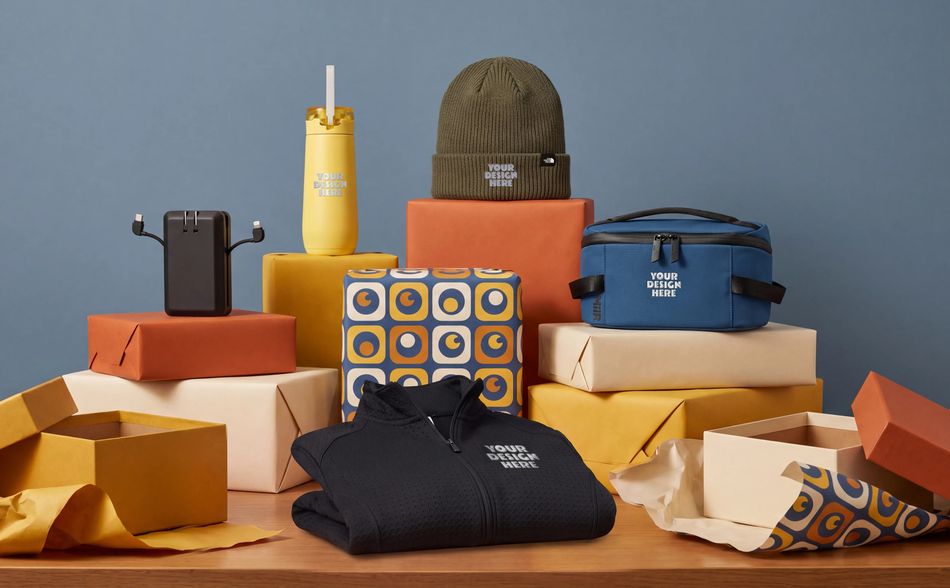 A gift table displaying technology, drinkware, outerwear, bag, and beanie hat.