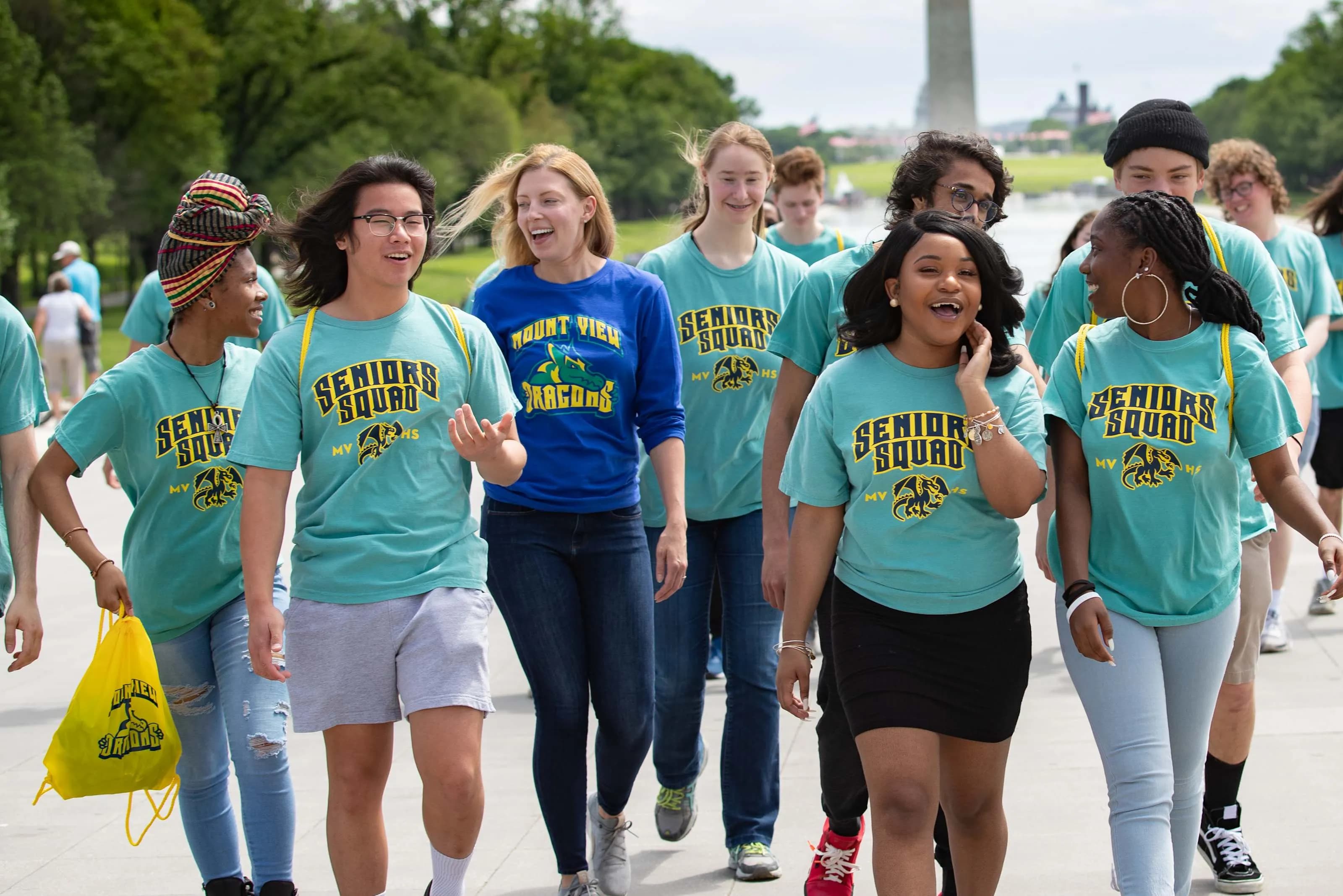 Group of seniors, wearing matching "Senior Squad" t-shirts walk along the national mall.