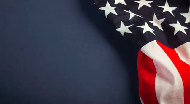 Close up image of an American flag on a navy blue background.