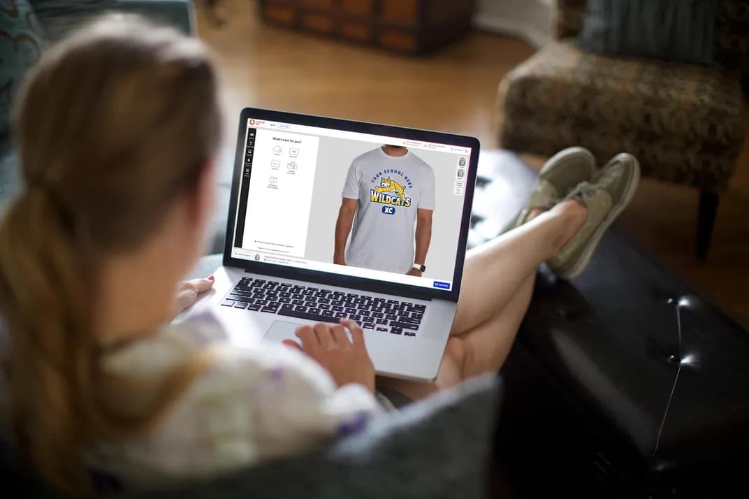 Customer on a laptop using the Custom Ink Design Lab to design a custom t-shirt.