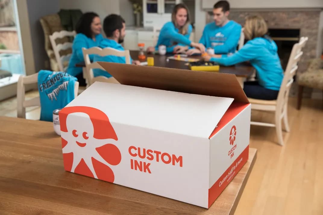 A custom ink package sitting next to a group of customers who received their custom products.