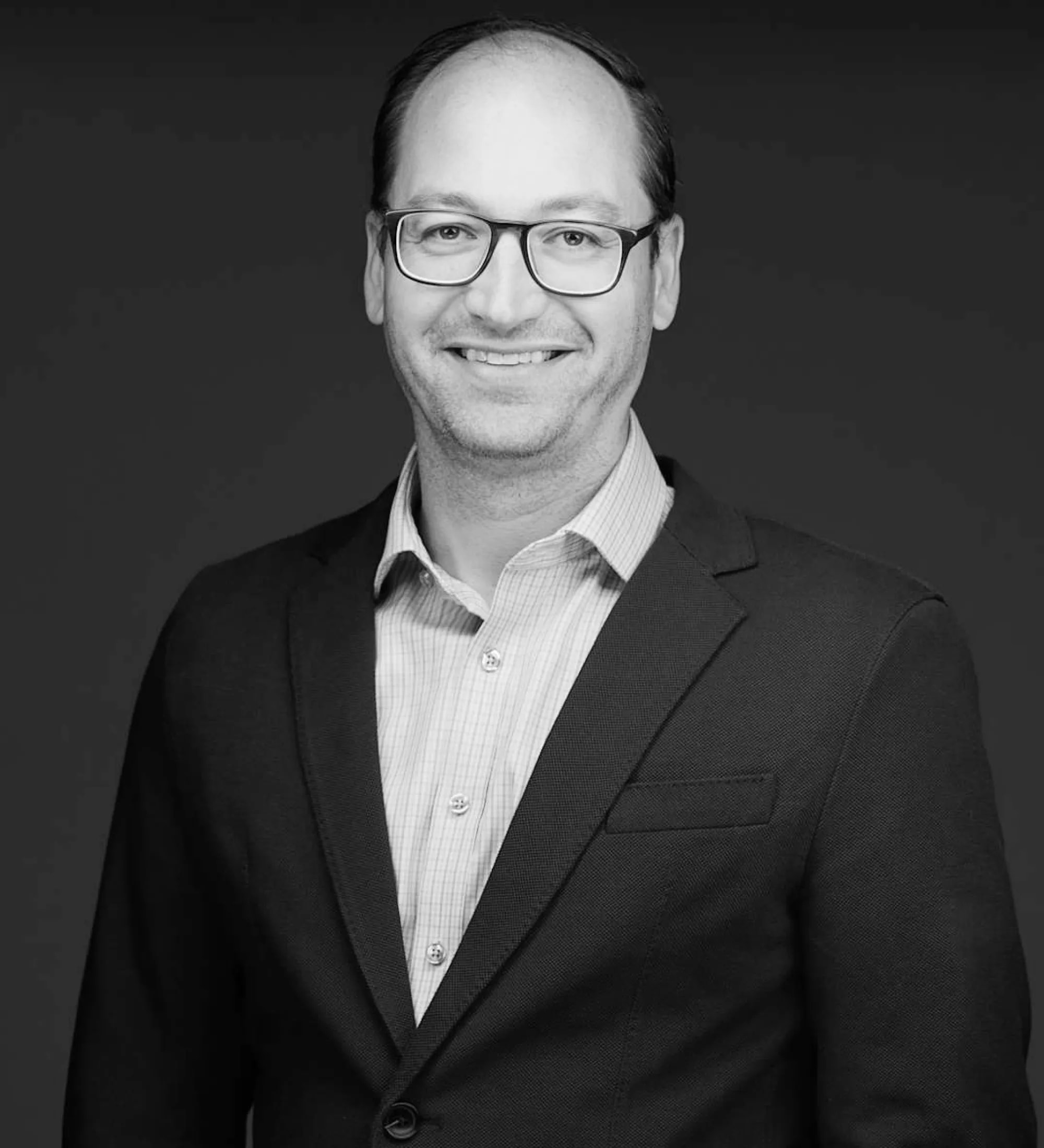 Portrait of Ben Litvinas in black and white.