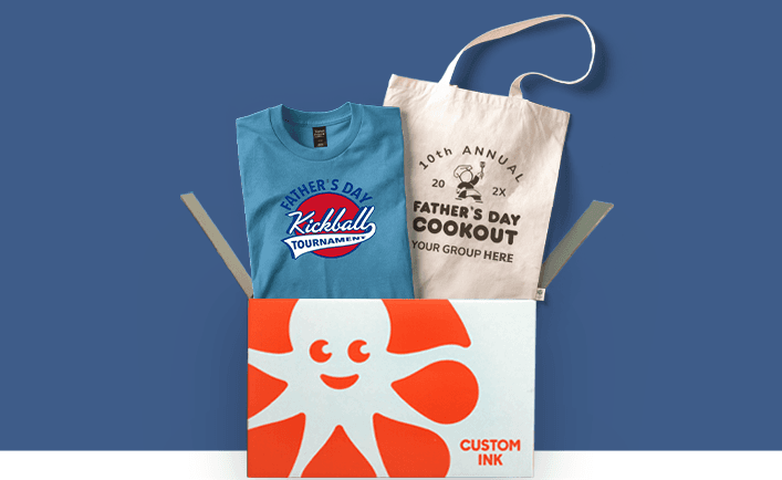 Custom Father's Day Kickball t-shirt and custom Father's Day Cook off tote bag coming out of a Custom Ink box.