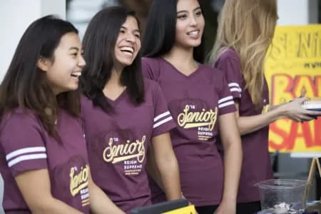 A group of students wearing coordinating custom t-shirts featuring "Seniors '18".