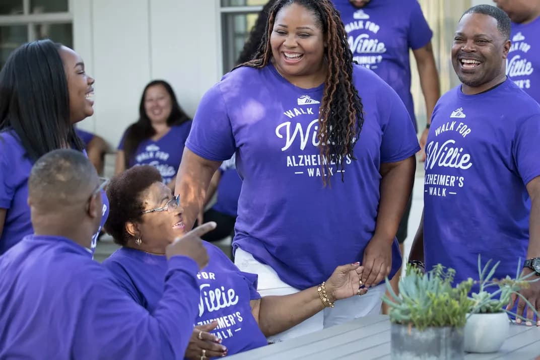 Group of people wearing matching custom purple t-shirts for an Alzheimer’s walk event.