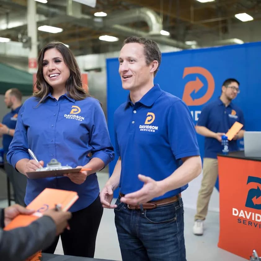 Davidson Services Employees wearing embroidered business shirts at a trade show.