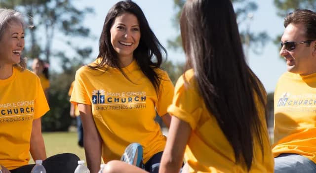 A religious group wears matching yellow custom t-shirts with "Maple Grove Church" logo.