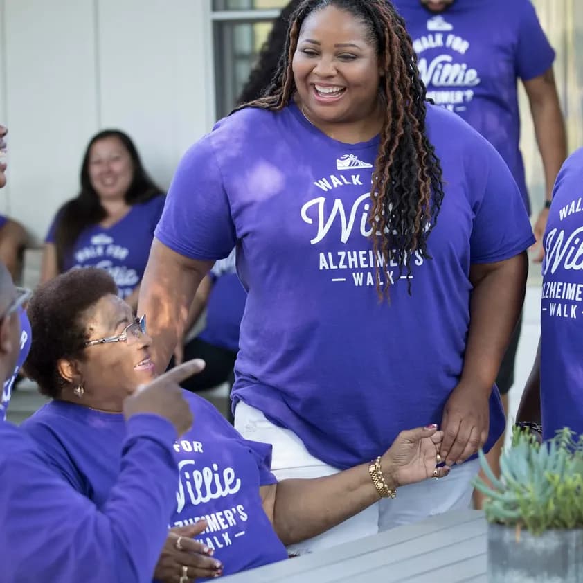Group of people wearing matching custom purple t-shirts for an Alzheimer’s walk event.
