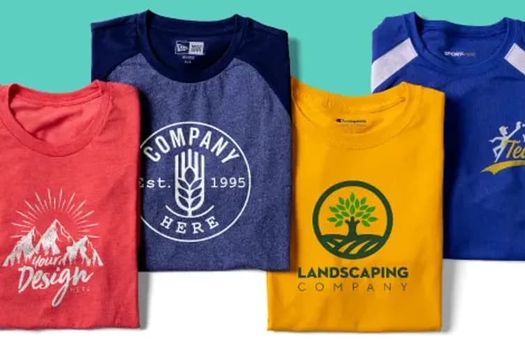 A laydown of folded custom t-shirts featuring a variety of brand logos.