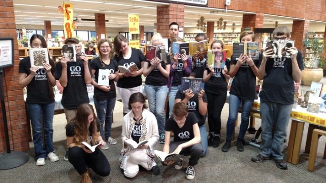 Reading Olympics team members celebrating their competition win with custom apparel