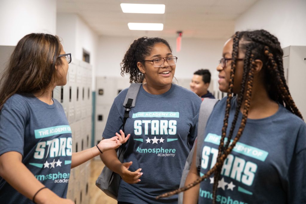 Students in the hallway in their custom shirts
