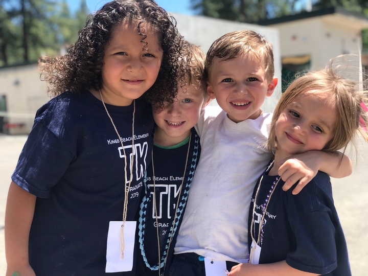 Kindergarten teachers in matching custom apparel at a meet-and-greet event