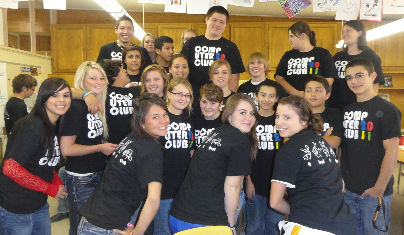 Tech club members in custom shirts celebrating computer science and coding culture