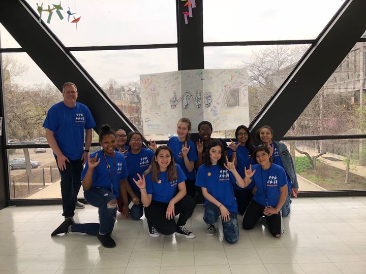 ASL club members in custom apparel celebrating sign language and Deaf culture