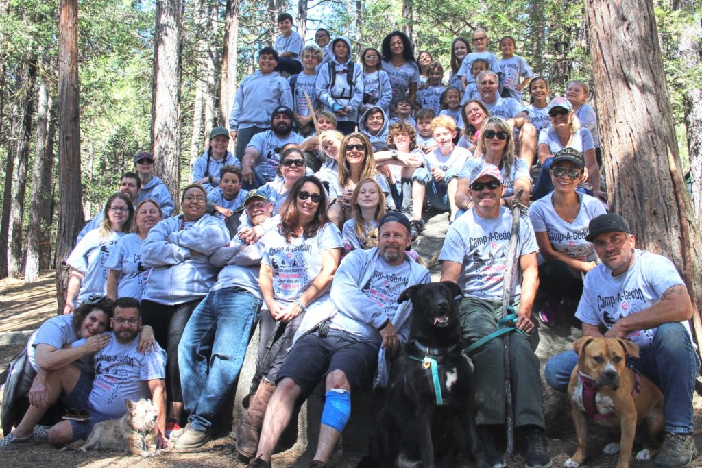 Large group of people wearing matching "Camp-a-geddon" shirts