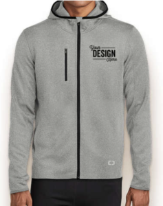 A person wearing a Heather Gray OGIO Endurance Stealth Zip Hoodie in front of a white background. "Your Design Here" is displayed on the left chest area in black ink. 
