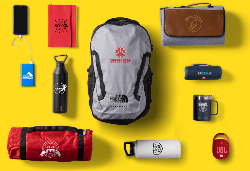 An array of customizable products including a portable charger, notebook, water bottle, backpack, blanket, speaker, and mug.