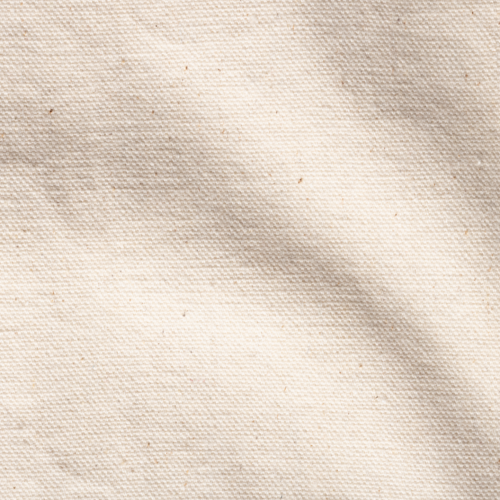 A close-up of beige recycled t-shirt fabric. It has the same look and feel as the fabric it originated from but with the added benefit of being good for the planet. 