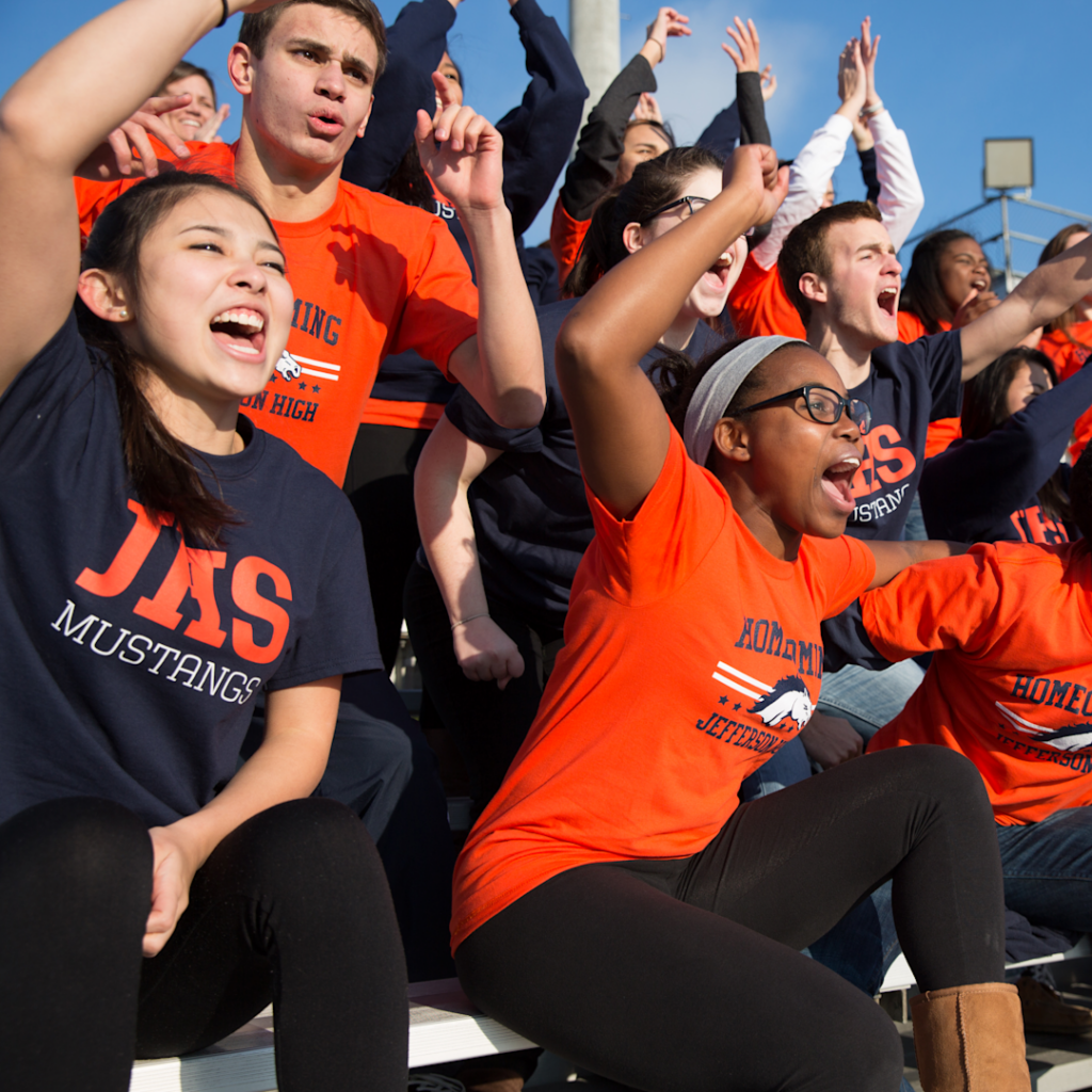 students in spirit wear cheering at a game