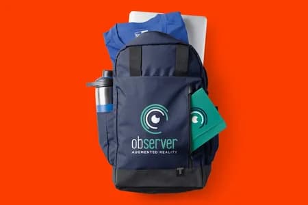 A laydown of a custom branded backpack with other custom products including Water Bottle, Notebook, and T-shirt.