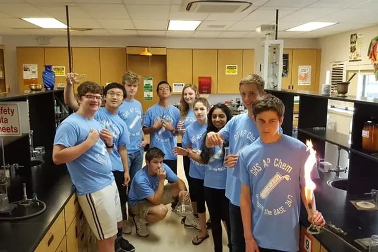High school chemistry students wearing matching custom light blue AP Chem t-shirts in a science lab.
