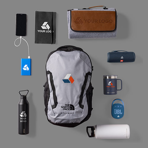 A variety of promotional products, like backpacks, notebooks, pens, travel mugs, water bottles, bluetooth speakers, and powerbanks, all customized with logos.