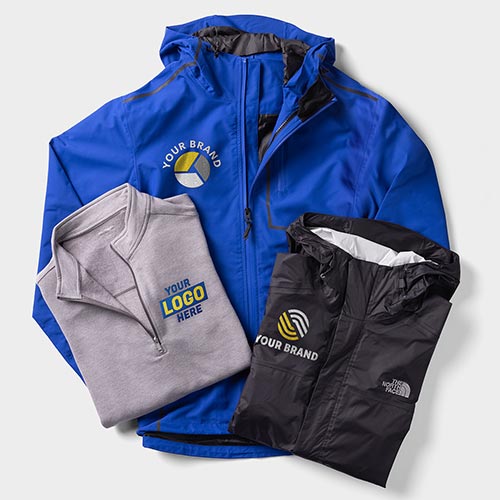 An insulated jacket, windbreaker, and lightweight zip-up customized with logos.