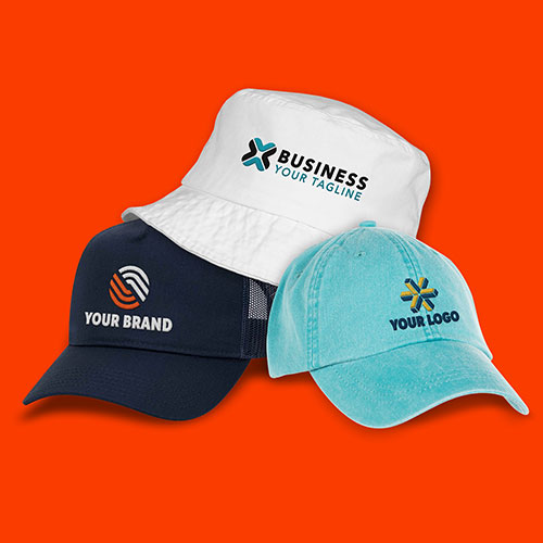 A custom bucket hat, dad hat, and trucker hat are all positioned together.